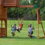Backyard Discovery Skyfort II Cedar Wood Playset Swing Set with Raised Clubhouse Wave Slide Monkey Bars and Rock Climbing Wall - Image 3